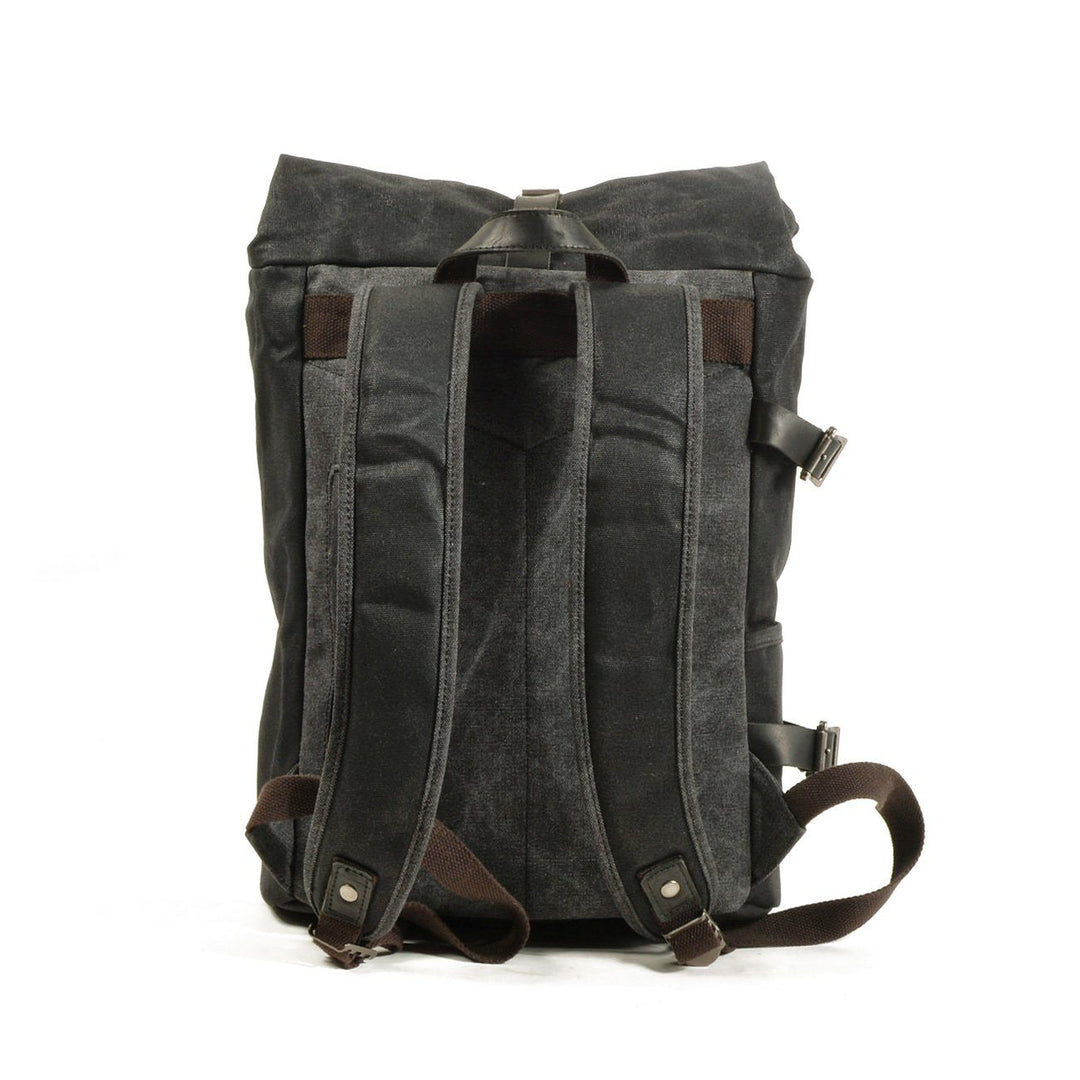 Angle view of the Gstaad biker backpack styling showing leather flap and brass hardware
