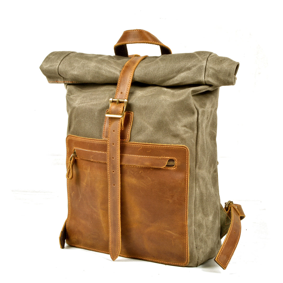 Three-quarter view of the army green Hanover rolltop rucksack revealing depth and leather strap closure system