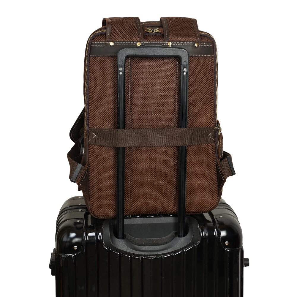 brown high quality leather backpack mounted on a travel suitcase