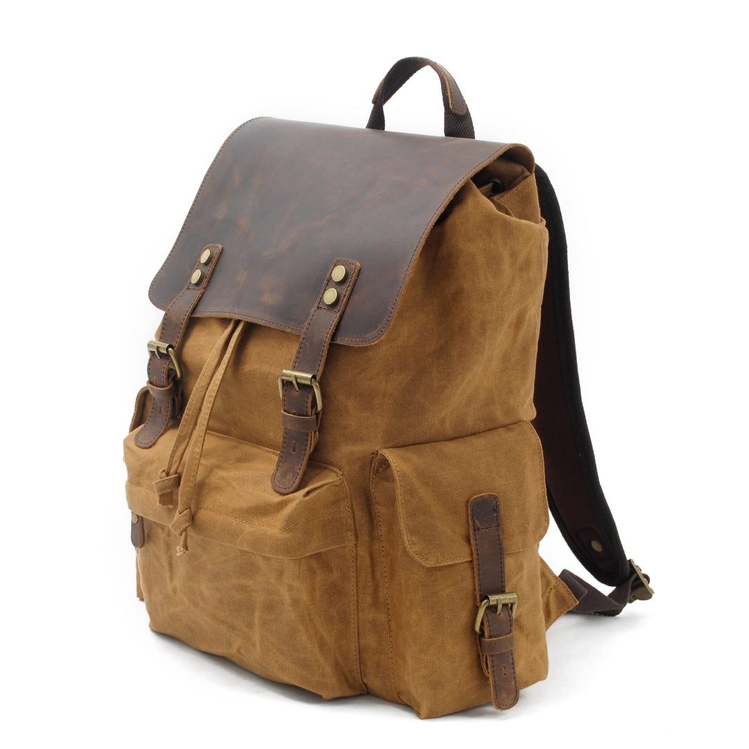 Three-quarter view of the khaki Latvia oiled canvas backpack styling showing side cargo pocket and reinforced edges