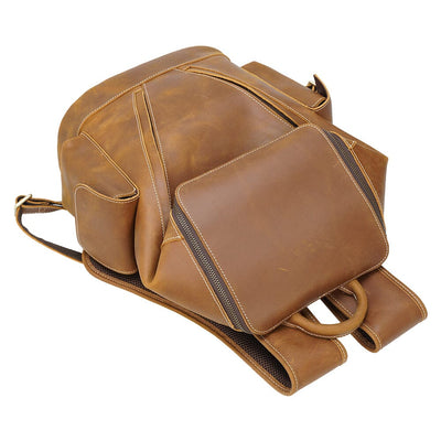 coffee leather backpack bag laying on the floor