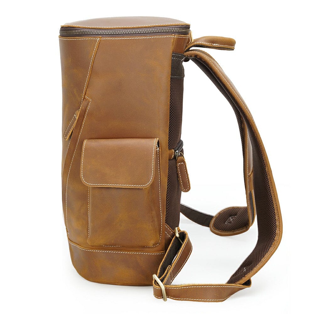 side of a coffee leather style backpack with padded back panel and shoulder straps