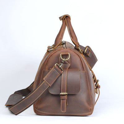 side view of a leather travel duffle bag, coffee color