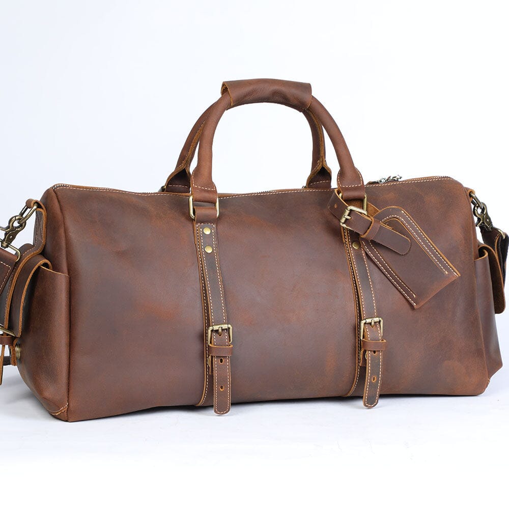 doubled top leather handles of a leather duffle