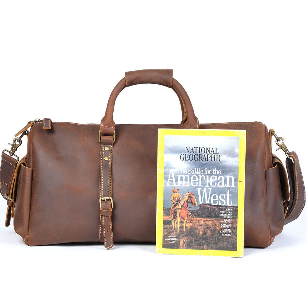 Magazine in front of a stylish Leather Travel Duffle Bag