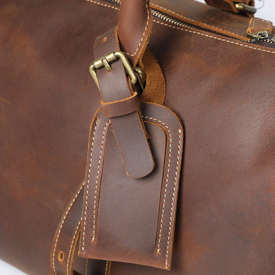 Leather luggage tag on a leather travel bag