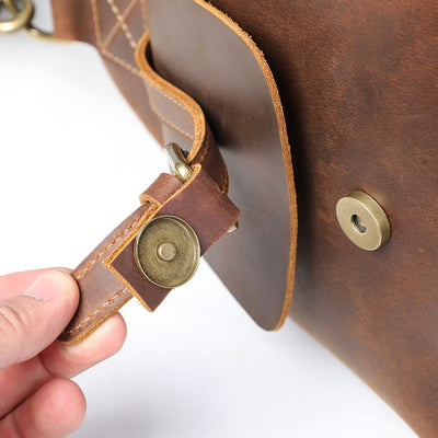 Close-up of magnetic buckle exterior pocket detail on Leather Travel Duffle