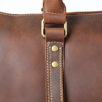 Close-up of top handles reinforced rivet detail on Leather Travel Duffle