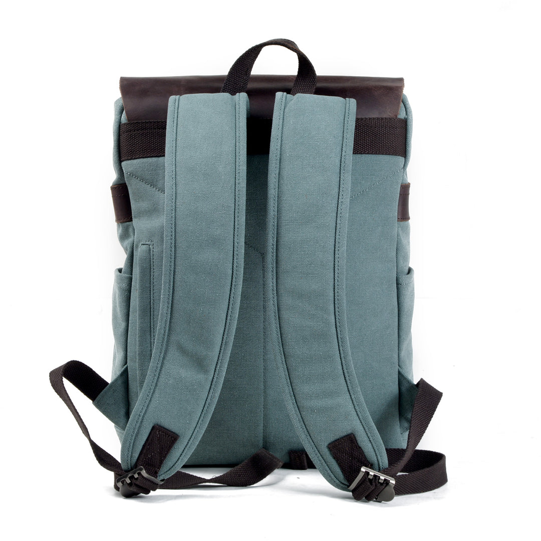 Milan cotton backpack styled for everyday carry with leather strap closures and antiqued brass hardware
