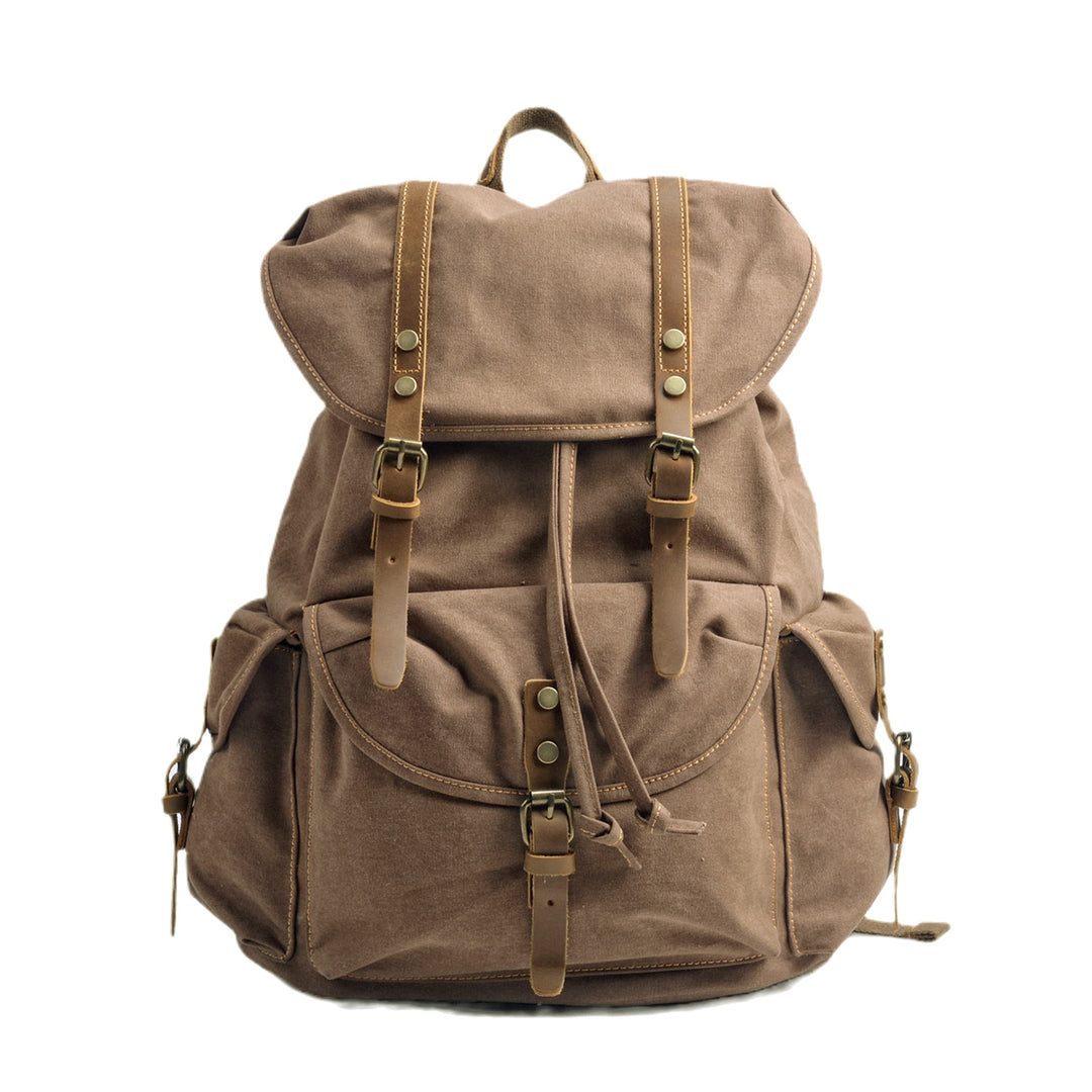 Vintage canvas rucksack in coffee brown with twin leather strap closures, antiqued brass buckles, drawstring opening and large front pocket — Montreal