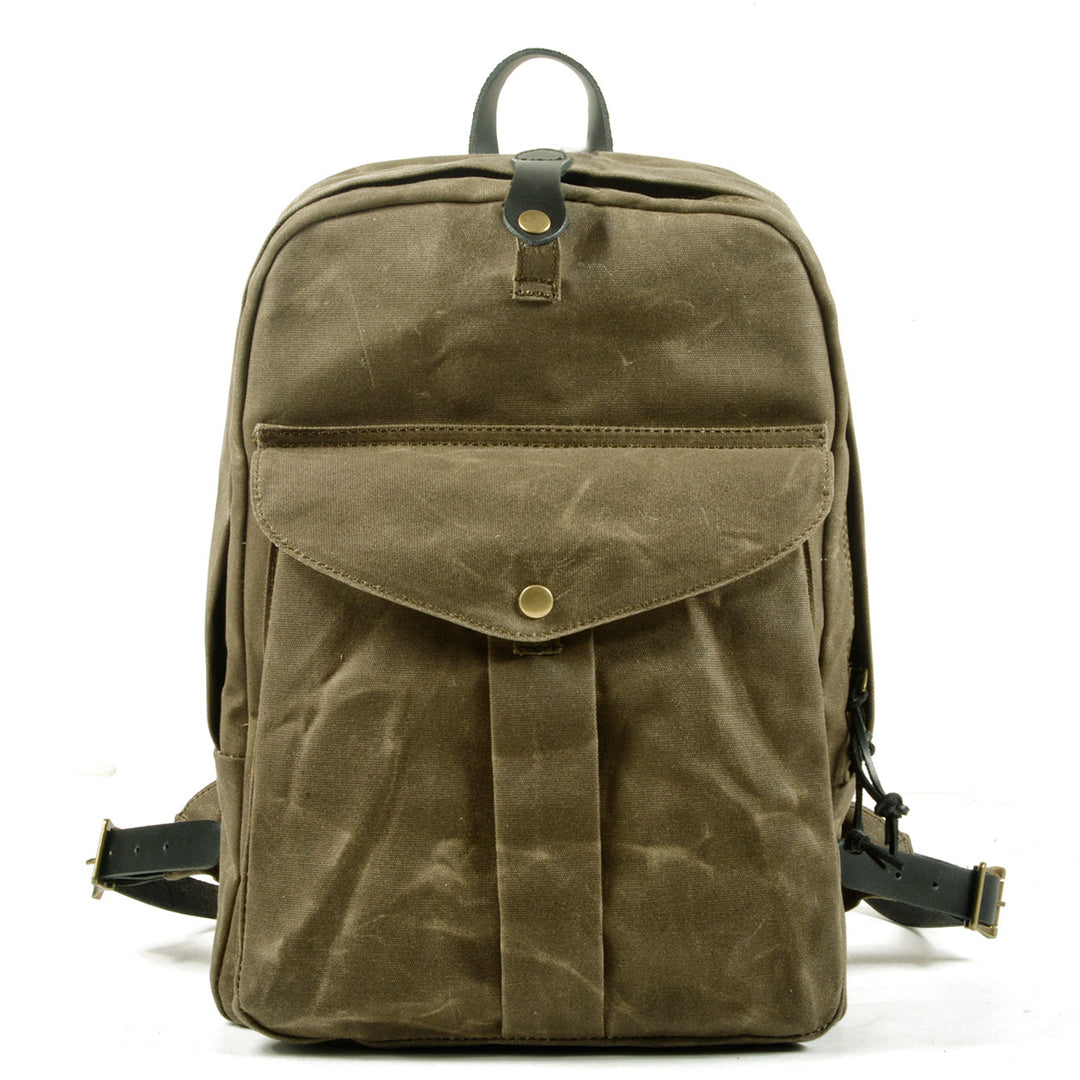 Plain canvas backpack in army green with leather top tab, brass snap closure and slim vertical rectangular silhouette — Ystad
