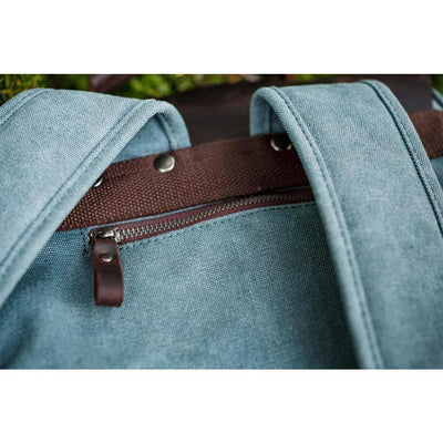 retro backpack helsinki, close up, hidden anti-theft zipped back pockets and reinforced shoulder straps with rivets