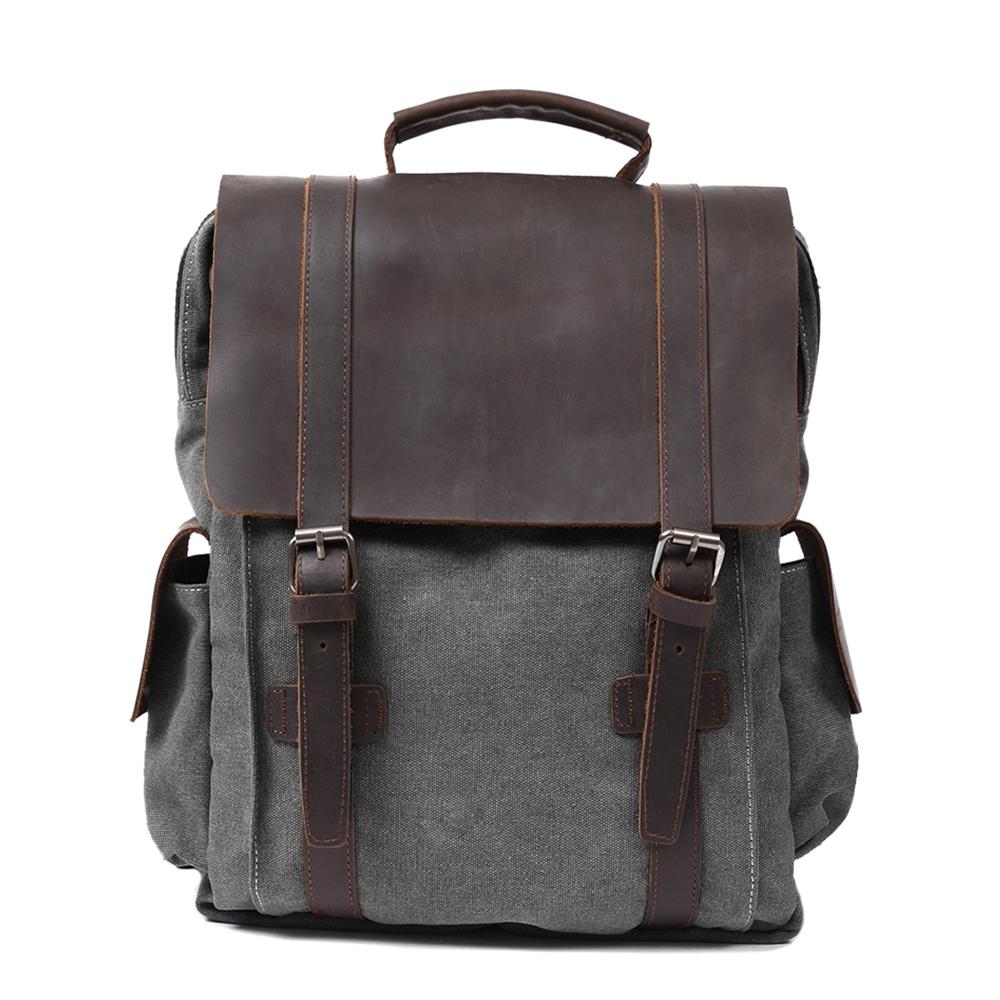 Small canvas backpack in dark grey with crazy horse leather trim and antiqued brass buckles — Manitoba