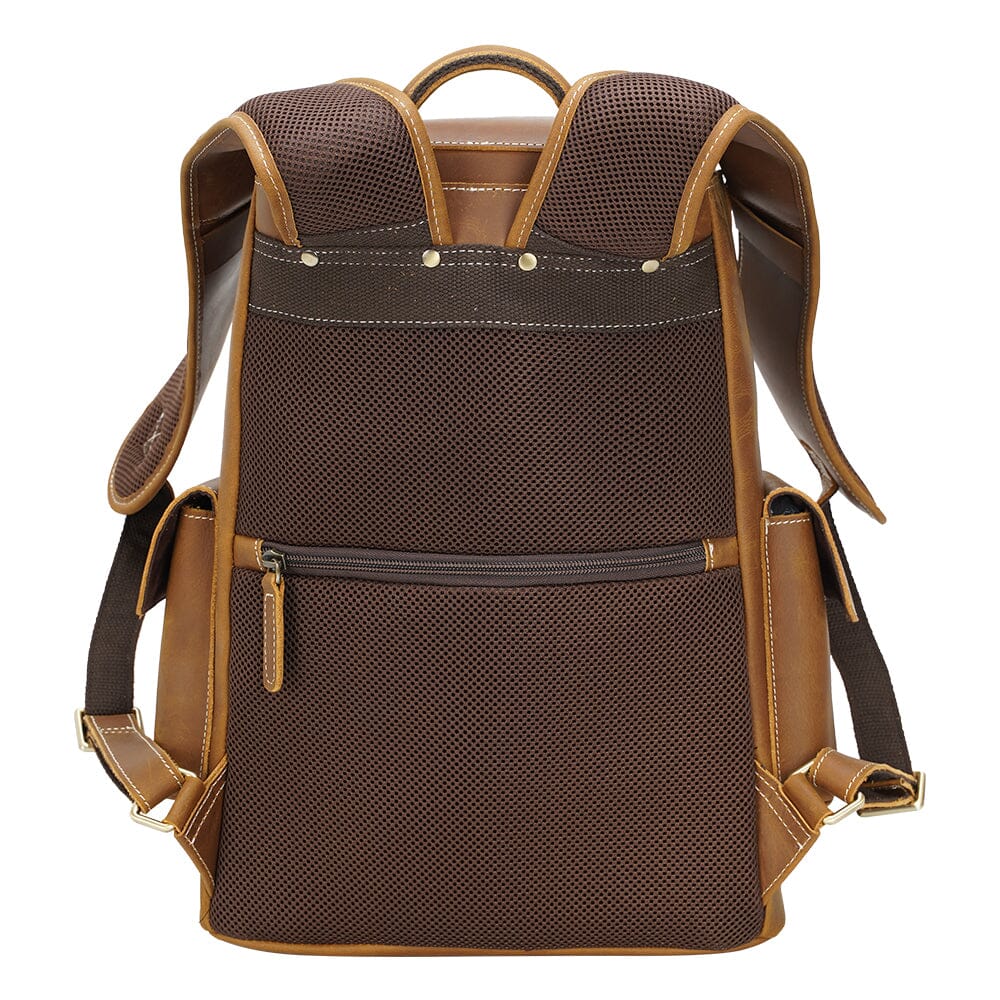 padded and rivet reinforced shoulder straps of a smooth leather backpack
