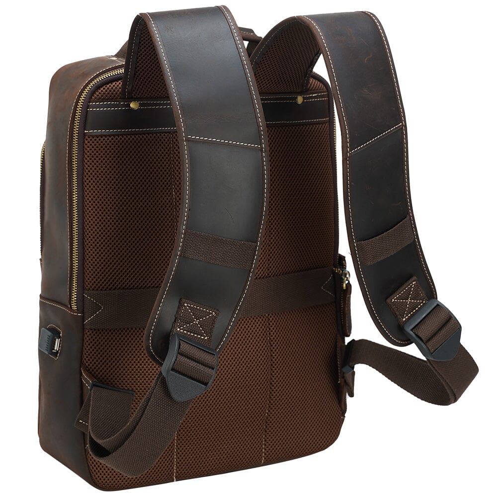 padded mesh back panel of a brown unisex leather backpack