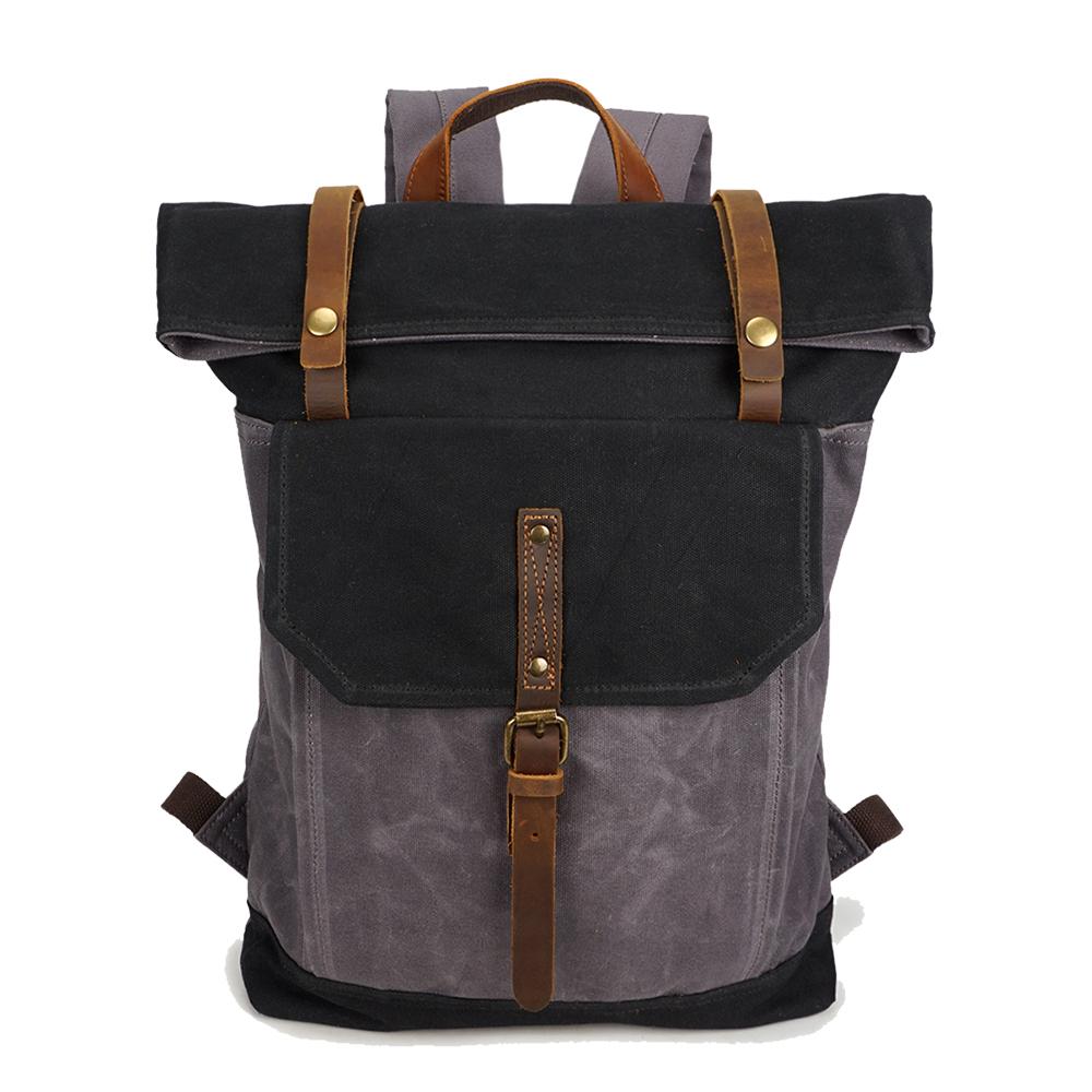 Vintage backpack in black waxed canvas with crazy horse leather flap and brass hardware, classic silhouette — Yukon