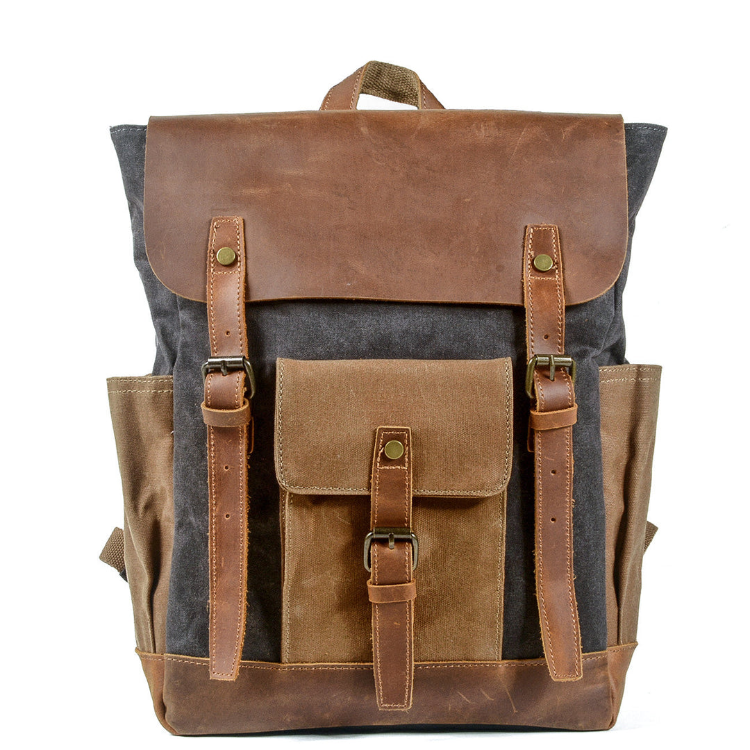 Canvas laptop backpack in black with full-grain leather flap, twin brass closures and dedicated padded laptop sleeve — Göteborg